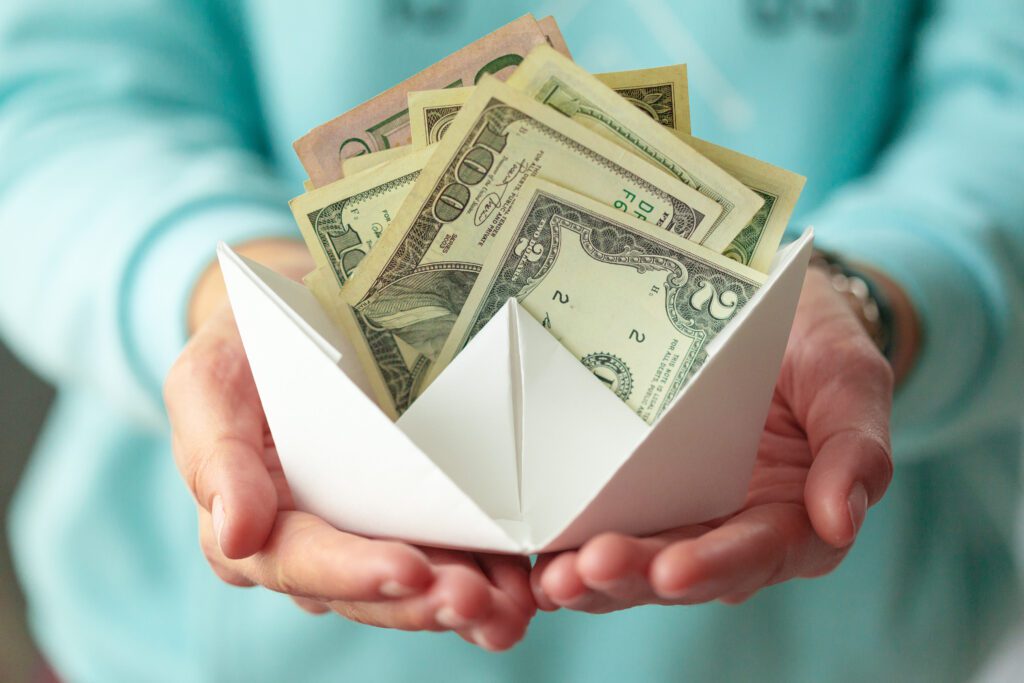 Money Banknotes And Paper Boats. Business Concept