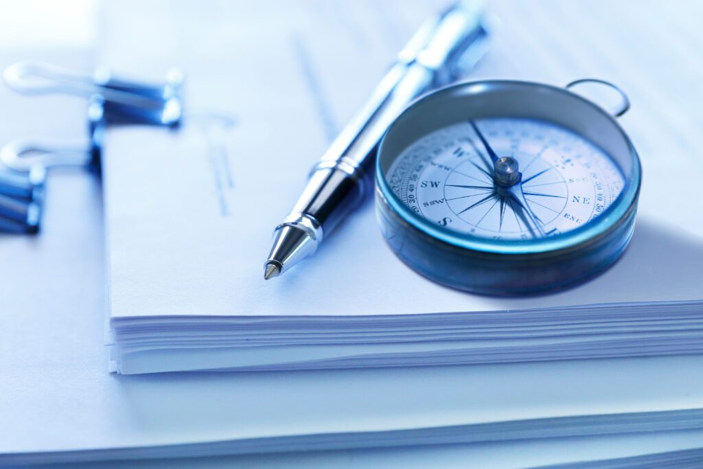 Compass And Pen On Stack Of Legal Documents